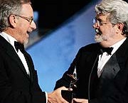 Steven Spielberg, left, presents the lifetime achievement award to George Lucas at the American Film Institute's Life Achievement Awards. / Getty Images